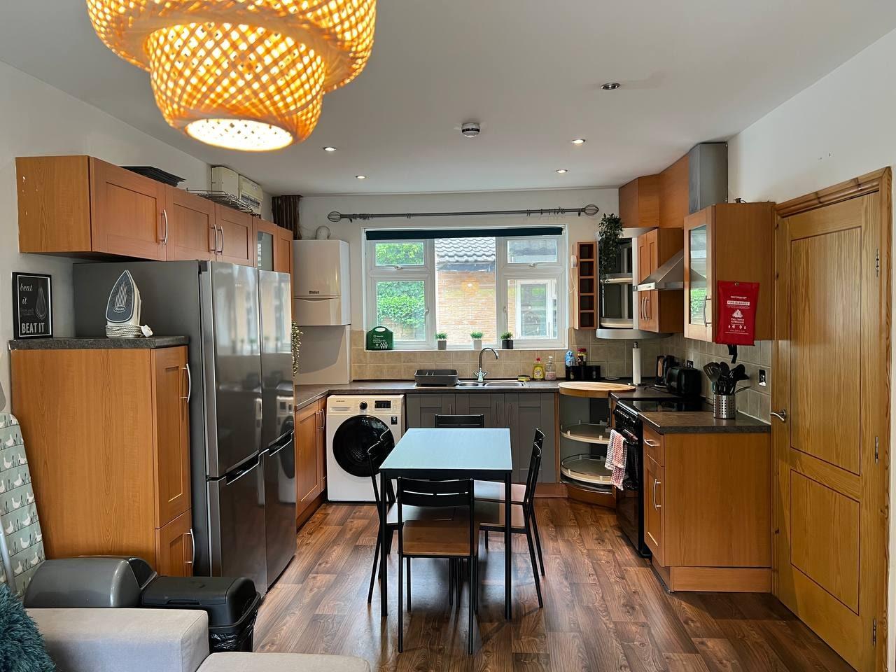 Fitted kitchen with dining table and American-style fridge-freezer — Greenhead Road, Huddersfield