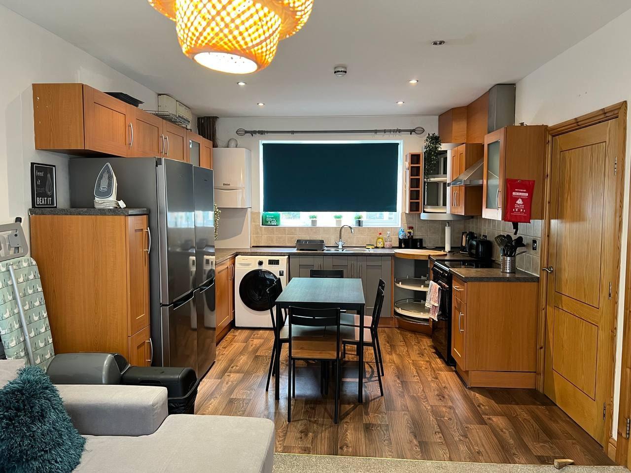 Kitchen and dining area with wood flooring and a large window — Greenhead Road, Huddersfield